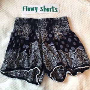 black flow-y shorts with white and grey detailing.